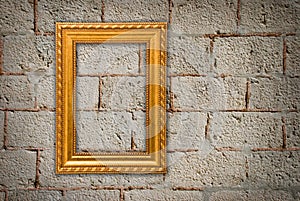 Gold frame on a old wall