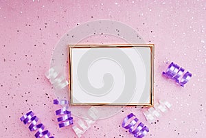 Gold frame on a pink background, serpentine, confetti. Place for text. Festive background. Event. Birthday Conception. Flat lay. T