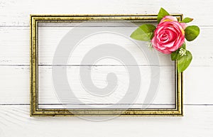 Gold frame and a pink rose