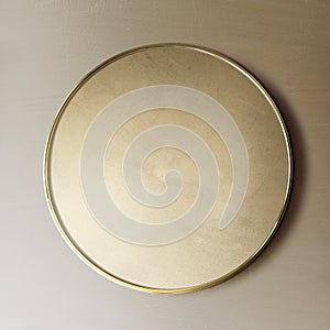 Gold framed mirror on a brown wall