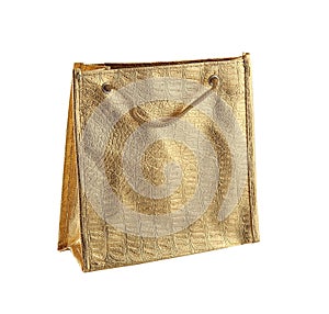 Gold gift bag isolated on the white background. It is a small bag with an embossed pattern. It is intended for shopping