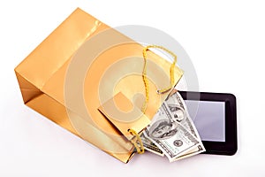 Gold gift bag with a Tablet and dollars