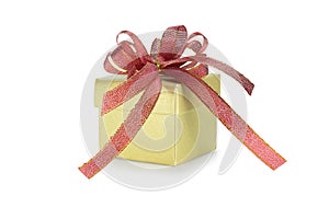Gold gift box with red ribbon. New year gift. christmas present.