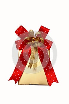 Gold gift box with red ribbon on white.