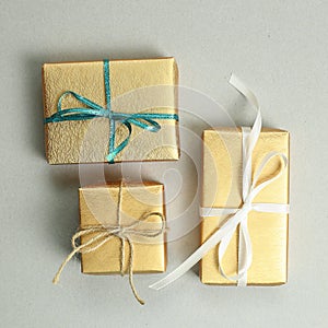 Gold gift boxes on gray background