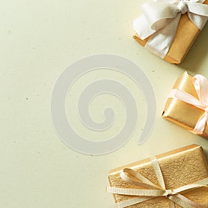 Gold gift boxes on khaki green background