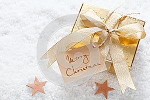 Gold gift with Merry Christmas tag