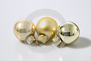 Gold glass christmas balls in a white background