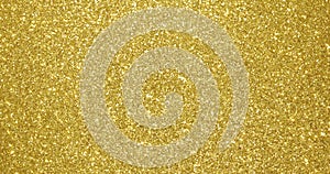 Gold glitter background, sparkling shimmer glow particles texture. Golden light sparks and glittering foil sequins background with