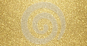 Gold glitter background with sparkling texture. Golden shimmering light, stars sequins sparks and glittering glow foil background