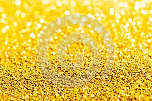 Gold glitter close-up background with shallow depth of field