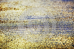 Gold glitter on dark blue bokeh abstract light defocused background.