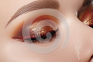 Gold glitter Eyes Make-up, bright red liner. Fashion Celebrate Makeup, Clean Skin, perfect eyebrows. Metalic eye shadows
