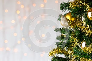 Gold glitter robin on Christmas tree. Copy space.