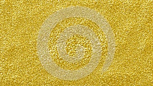 Gold glitter shining abstract background. rough textured golden glitter surface