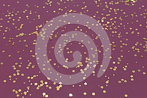 Gold glitter stars on a purple background