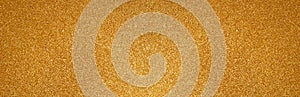 Gold glitter texture sparkling paper background. Abstract banner with twinkled golden glittering. Defocused lights for Christmas