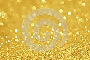 Gold glittering christmas lights. Blurred abstract background