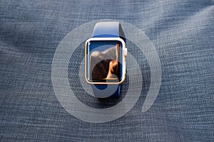 Gold golden blue smart watch turn off black screen close up