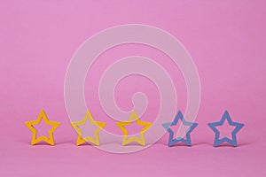 Gold, gray, silver five stars shape on a pink background. Increase rating or ranking, evaluation and classification idea. Three 3