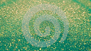 Gold & green glitter bokeh background. Abstract glittering shimmer. Vintage lights shiny backdrop. Golden dust sparkles.