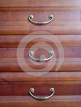 Gold handles in brown drawers