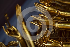 Gold hands of image buddha in buddhist temple