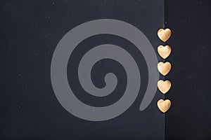 Gold heart stickers on dark texture background