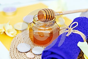 Gold honey in a jar, orchid flowers, towels and scented candles