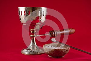 Gold incense chalice on red velvet background