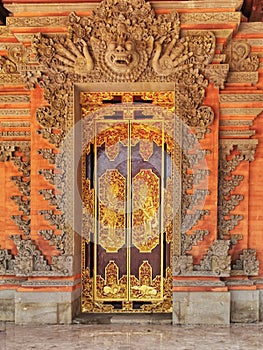 Gold incrustated door to a traditional private dwelling on Bali island in Indonesia