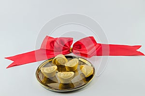 Gold ingot on golden a plates white background