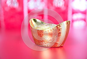 Gold ingot ornaments on red background