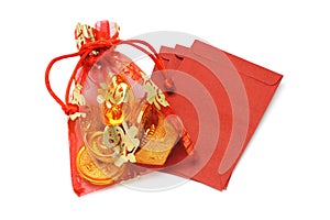 Gold ingots and coins in decorative sachet