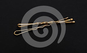 Gold invisible hair pins on black
