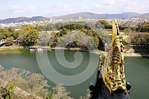 Gold Japanese fish statue on top of Okayama castle and river view in Okayama city, Japan