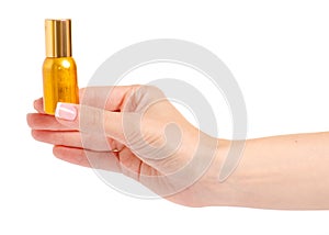 Gold jar of nail polish oil in hand