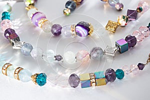 Gold jewelry bracelets  with semiprecious and crystal at white background