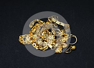 Gold jewelry with gold chain ring earring with black background