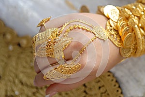 Gold jewelry on the hands of a Muslim bride.