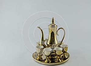 Gold jug Tea glass white background .