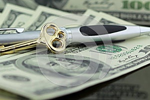 Gold key on hundred dollar bills