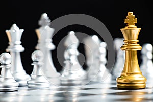 Gold king chess piece face with silver team on black background Concept for company strategy, business decision and encounter the