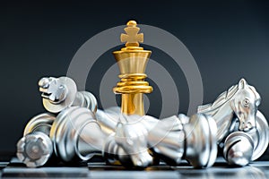 Gold king chess piece win over lying down silver team