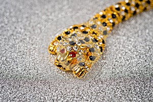 Gold leopard bracelet with shiny pebbles, lepard eyes made of bright red stones