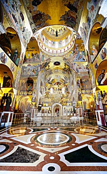 Gold lighted altar central gallery, cathedral church. Byzantium stile interior. Montenegro.