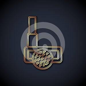 Gold line Golf club with ball icon isolated on black background. Vector