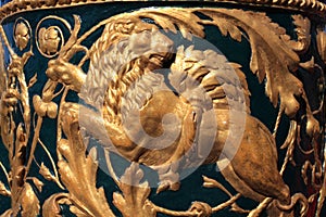 Gold lion from a bowl of a fencing