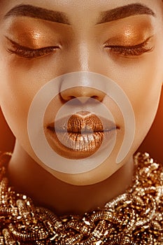 Gold Luxury black skin woman African Ethnic female face. Young african american model with jewelry