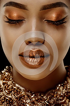 Gold Luxury black skin woman African Ethnic female face. Young african american model with jewelry photo